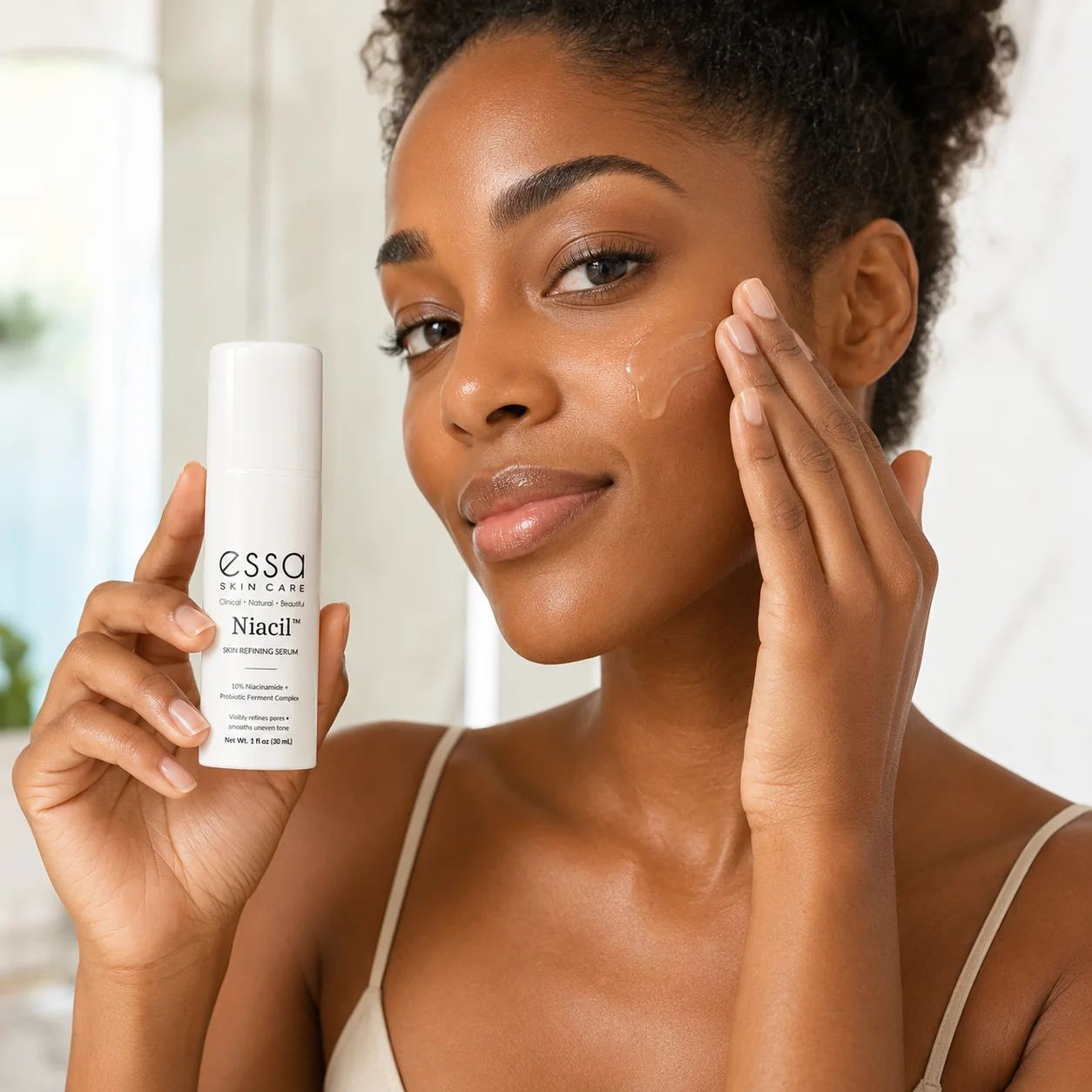 Woman applying Essa Niacil serum